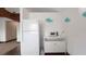 Bright kitchenette with a white refrigerator, microwave and wooden beam at 6322 Aureau Ave, Hudson, FL 34667