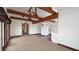 Open-concept living space featuring exposed beams and a combined living and kitchen area at 6322 Aureau Ave, Hudson, FL 34667
