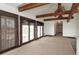 Cozy living area with exposed beams and abundant natural light from balcony access at 6322 Aureau Ave, Hudson, FL 34667
