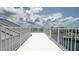 Scenic rooftop deck with white railing, ideal for relaxing and enjoying the surrounding views at 6322 Aureau Ave, Hudson, FL 34667