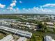 Overhead view of waterfront homes with boat docks and a bridge connecting to the mainland, surrounded by lush greenery at 639 Garland Cir, Indian Rocks Beach, FL 33785