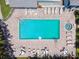 Aerial view of the community pool, surrounded by chairs, tables and well-manicured landscaping at 639 Garland Cir, Indian Rocks Beach, FL 33785