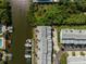 Aerial shot features waterfront residences with private boat docks along a scenic canal, surrounded by mature trees at 639 Garland Cir, Indian Rocks Beach, FL 33785