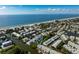 Aerial view of a coastal neighborhood, showcasing houses and boats along the waterway near the ocean at 639 Garland Cir, Indian Rocks Beach, FL 33785