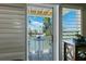 Waterfront balcony featuring table and chairs overlooking serene canal and neighboring homes at 639 Garland Cir, Indian Rocks Beach, FL 33785