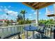 Waterfront balcony featuring cozy seating and panoramic views of the tranquil canal and surrounding homes at 639 Garland Cir, Indian Rocks Beach, FL 33785