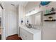 Bright bathroom with double vanity, large mirror, and marine-themed decor at 639 Garland Cir, Indian Rocks Beach, FL 33785