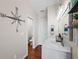 Bright bathroom with a double vanity, modern lighting, and a compass-themed decoration at 639 Garland Cir, Indian Rocks Beach, FL 33785
