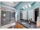 Bright bathroom with modern vanity, bathtub and shower combination, plus nautical decorations at 639 Garland Cir, Indian Rocks Beach, FL 33785