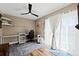 Comfortable bedroom featuring wood flooring and access to a screened patio via sliding glass door at 639 Garland Cir, Indian Rocks Beach, FL 33785