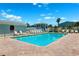 Inviting community pool area with ample seating, surrounded by lush palm trees, offering a relaxing atmosphere at 639 Garland Cir, Indian Rocks Beach, FL 33785