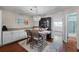 Light and airy dining area with a modern light fixture and an elegant china cabinet at 639 Garland Cir, Indian Rocks Beach, FL 33785