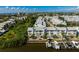 Close aerial highlights waterfront condos with docks, balconies, and lush landscape, ideal for boating and serene living at 639 Garland Cir, Indian Rocks Beach, FL 33785