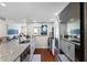 Kitchen offers granite counters, stainless steel appliances, and a seamless connection to the living room at 639 Garland Cir, Indian Rocks Beach, FL 33785