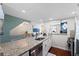 Bright kitchen, granite countertops, stainless steel appliances, and seamless access to the living area at 639 Garland Cir, Indian Rocks Beach, FL 33785