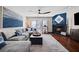 Inviting living room features a large sofa, hardwood floors, and a fireplace, perfect for relaxing at 639 Garland Cir, Indian Rocks Beach, FL 33785