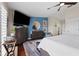 A well-lit main bedroom features a blue accent wall, ceiling fan and stylish decor at 639 Garland Cir, Indian Rocks Beach, FL 33785