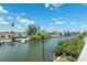 Scenic view of a calm canal lined with waterfront homes and lush greenery, under a partly cloudy sky at 639 Garland Cir, Indian Rocks Beach, FL 33785