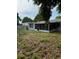 Spacious yard with screened in porch; mostly patchy dirt with small amount of grass at 7222 Coventry Dr, Port Richey, FL 34668