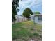 Large, fenced backyard providing privacy and security; some grass and mostly patchy dirt at 7222 Coventry Dr, Port Richey, FL 34668
