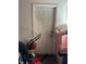 Neutral door with a lawn mower, boxes and other belongings in the basement of the home at 7222 Coventry Dr, Port Richey, FL 34668