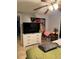 Well-lit bedroom with ceiling fan and television and view into other rooms of the home at 7222 Coventry Dr, Port Richey, FL 34668