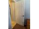 Neutral interior door and door frame, with a carpeted floor and adjacent wooden shelving at 7222 Coventry Dr, Port Richey, FL 34668
