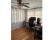 Functional home office area, featuring a desk, ergonomic chair, and ample natural light for productivity at 7222 Coventry Dr, Port Richey, FL 34668