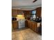 Functional kitchen featuring wood cabinets and a white range at 7222 Coventry Dr, Port Richey, FL 34668