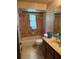Retro bathroom featuring a combined tub and shower, tiled walls, and a vanity with sink at 7239 Lykes Dublin Rd, Brooksville, FL 34601