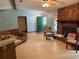 Inviting living room featuring a rock fireplace, ceiling fan, and neutral-toned walls at 7239 Lykes Dublin Rd, Brooksville, FL 34601