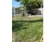 Backyard featuring chain-link fence, grass, and some debris at 7540 Briarwood Dr, Port Richey, FL 34668
