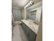 Spacious bathroom with double sink vanity and mirror, plus shower at 7540 Briarwood Dr, Port Richey, FL 34668