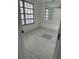 Bright bedroom featuring a window with lots of light and tile flooring at 7540 Briarwood Dr, Port Richey, FL 34668