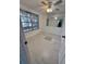 Cozy bedroom featuring tile floors, a ceiling fan and lots of natural light at 7540 Briarwood Dr, Port Richey, FL 34668