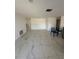 Bright, open-concept living room with light tile flooring and neutral walls, creating an airy feel at 7540 Briarwood Dr, Port Richey, FL 34668