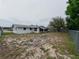 Large backyard enclosed by a fence, offering a private outdoor area with ample space for activities at 7608 Bougenville Dr, Port Richey, FL 34668