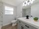 Bathroom featuring white marble backsplash, modern vanity and black hardware at 7608 Bougenville Dr, Port Richey, FL 34668