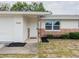 Inviting front entrance features a decorative support beam and a well-maintained landscaped area at 7608 Bougenville Dr, Port Richey, FL 34668