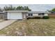 Charming single-story home with brick accents, updated windows, and a one car garage at 7608 Bougenville Dr, Port Richey, FL 34668