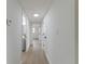 Hallway featuring neutral paint, and wood floors leading to various rooms at 7608 Bougenville Dr, Port Richey, FL 34668