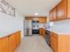 Updated kitchen showcasing stainless steel appliances, light countertops, and wood cabinets at 7608 Bougenville Dr, Port Richey, FL 34668