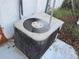A close-up of an outdoor air conditioning unit at 7631 Briarwood Dr, Port Richey, FL 34668