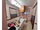 View of pink bathroom featuring a vanity, mirror and walk-in shower at 7631 Briarwood Dr, Port Richey, FL 34668