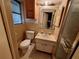 Vintage bathroom with yellow tile, and matching fixtures, including a pedestal sink and toilet at 7631 Briarwood Dr, Port Richey, FL 34668