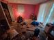 View of pink bedroom with a window, a desk and items scattered around at 7631 Briarwood Dr, Port Richey, FL 34668