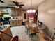 View of the dining room with a glass table and 3 chairs next to kitchen area at 7631 Briarwood Dr, Port Richey, FL 34668