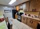 Kitchen with older appliances and outdated cabinets in need of updating at 7631 Briarwood Dr, Port Richey, FL 34668