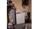 Picture of a laundry room with a water heater and washing machine at 7631 Briarwood Dr, Port Richey, FL 34668