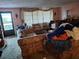 View of a cluttered living room filled with furniture and personal belongings at 7631 Briarwood Dr, Port Richey, FL 34668